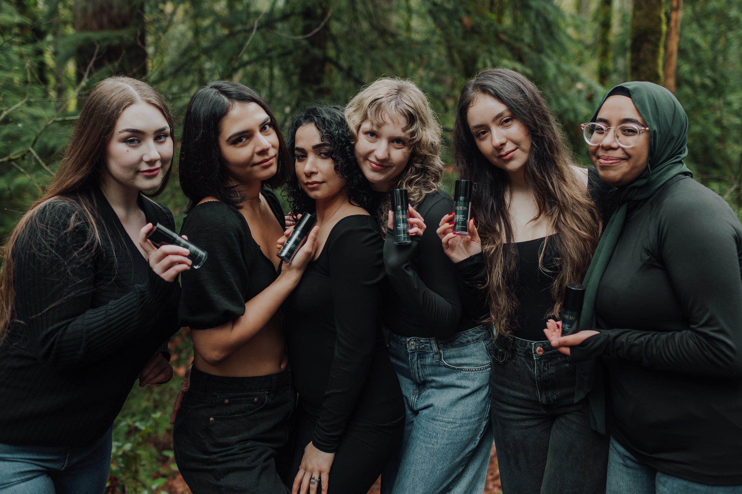 Group of women in woods holding Barrier Plus Pigment Potion