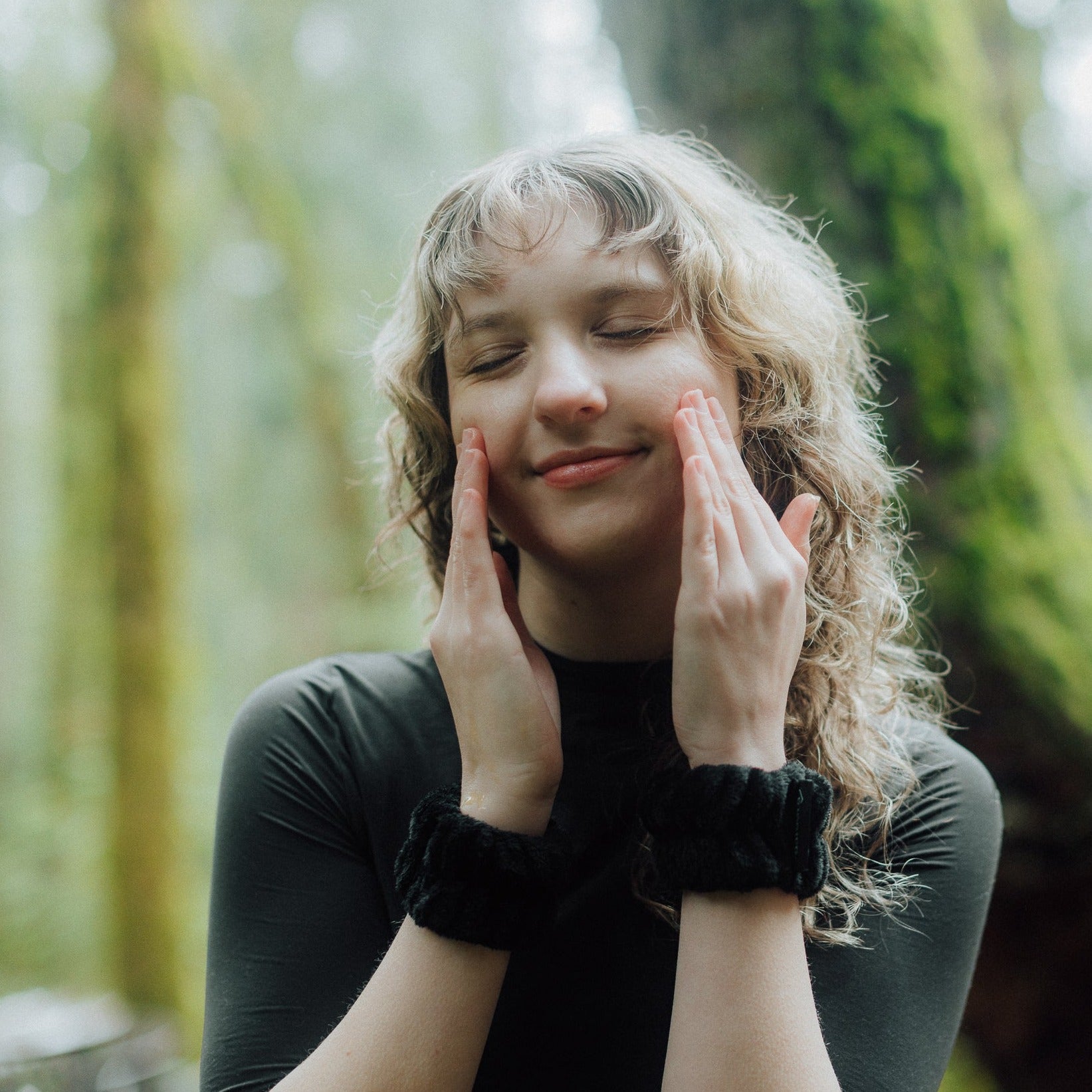 Woman wearing two black wristbands for Barrier Plus Skin